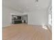 Spacious living room with hardwood floors and view of the kitchen with a dark island at 2894 Matese Dr, Henderson, NV 89052