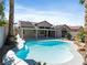 This backyard features a sparkling pool and an expansive covered patio at 2894 Matese Dr, Henderson, NV 89052