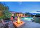 Inviting backyard space with pool, fire pit, and elegant patio furniture at 2901 Josephine Dr, Henderson, NV 89044