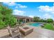 Serene backyard showcasing a pool, manicured landscaping, and a cozy fire pit area at 2901 Josephine Dr, Henderson, NV 89044