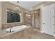 Luxurious bathroom featuring a soaking tub, walk-in shower, and stylish fixtures at 2901 Josephine Dr, Henderson, NV 89044