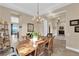 Open dining room with wood table, chandelier and view to the backyard at 2901 Josephine Dr, Henderson, NV 89044