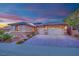 Charming home exterior featuring a manicured lawn, beautiful landscaping, and a three-car garage at 2901 Josephine Dr, Henderson, NV 89044