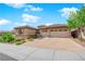 Attractive home exterior with a well-maintained yard, stone accents, and a spacious three-car garage at 2901 Josephine Dr, Henderson, NV 89044