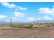 Expansive desert landscape featuring a luxury home with a tile roof and distant city views at 2901 Josephine Dr, Henderson, NV 89044