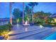 Atmospheric fire pit surrounded by comfortable seating and lush landscaping at 2901 Josephine Dr, Henderson, NV 89044
