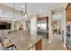 Open concept kitchen with a large island, stainless steel refrigerator, and bar stool seating at 2901 Josephine Dr, Henderson, NV 89044