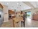 Bright kitchen with stainless appliances, island, and dining area overlooking the pool at 2901 Josephine Dr, Henderson, NV 89044