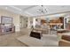 Inviting living room featuring an open floor plan, neutral decor, and seamless flow to the kitchen and dining area at 2901 Josephine Dr, Henderson, NV 89044