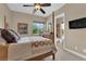 Cozy main bedroom with a four-poster bed, ceiling fan, and en-suite bathroom at 2901 Josephine Dr, Henderson, NV 89044