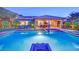 Night view of sparkling pool and stylish outdoor entertainment area at 2901 Josephine Dr, Henderson, NV 89044