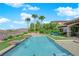 Stunning pool area with water features, palm trees, manicured lawn, and lounge chairs at 2901 Josephine Dr, Henderson, NV 89044