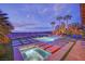 Stunning pool and spa featuring travertine decking and lush landscaping, ideal for outdoor enjoyment at 2901 Josephine Dr, Henderson, NV 89044