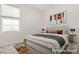 This bedroom features a large bed, neutral colors, and bright natural light at 3163 Biccari Ave, Henderson, NV 89044