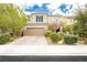 Inviting two-story home with a charming exterior, a well-manicured lawn, and a large two car garage at 3163 Biccari Ave, Henderson, NV 89044