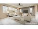 Bright living room featuring modern décor, neutral tones, large windows, and ample seating at 3163 Biccari Ave, Henderson, NV 89044