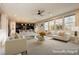 Open-concept living room with neutral decor, a ceiling fan, and an abundance of natural light at 3163 Biccari Ave, Henderson, NV 89044