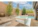 Backyard pool and spa with mature landscaping and brick privacy wall at 3163 Biccari Ave, Henderson, NV 89044