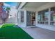 Stylish backyard with a covered patio, artificial grass, and glimpses of the kitchen at 3278 Turning Bridge St, Las Vegas, NV 89135