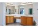 Bathroom featuring a dual sink vanity, and a large mirror with decorative lighting at 3278 Turning Bridge St, Las Vegas, NV 89135