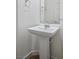 Elegant pedestal sink with chrome fixtures offers a classic touch to the half bathroom at 3278 Turning Bridge St, Las Vegas, NV 89135