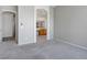 Neutral-toned bedroom showcasing plush carpeting, base trim and an arched doorway to an adjacent room at 3278 Turning Bridge St, Las Vegas, NV 89135