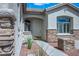 Welcoming front entrance with stone accents and a charming arched doorway at 3278 Turning Bridge St, Las Vegas, NV 89135