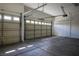 Spacious three car garage featuring automatic door openers, concrete floors, and ample space for vehicles at 3278 Turning Bridge St, Las Vegas, NV 89135