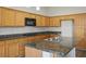 Spacious kitchen features wood cabinets, granite countertops, and stainless appliances, perfect for cooking at 3278 Turning Bridge St, Las Vegas, NV 89135