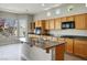 Bright kitchen with wooden cabinets, granite countertops, and stainless steel appliances provides a modern cooking space at 3278 Turning Bridge St, Las Vegas, NV 89135
