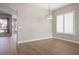 Bright and airy living room featuring stylish lighting fixture and wood laminate flooring at 3278 Turning Bridge St, Las Vegas, NV 89135