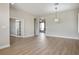 Open-concept living room with wood flooring, neutral walls, and arched doorways at 3278 Turning Bridge St, Las Vegas, NV 89135