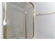 Tiled shower with glass door and gold hardware in the bathroom of this house at 3510 Judah Way, Las Vegas, NV 89147