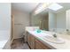 Bathroom featuring dual sinks, vanity lighting, and a skylight at 3510 Judah Way, Las Vegas, NV 89147