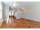 Spacious living room featuring hardwood floors, arched windows, and seamless kitchen access at 3510 Judah Way, Las Vegas, NV 89147