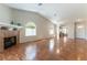Open living room with hardwood floors, a fireplace, and lots of natural light from arch windows at 3510 Judah Way, Las Vegas, NV 89147