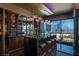 Stylish bar area with marble counters, seating, and city views through large windows at 4575 Dean Martin Dr # 1909, Las Vegas, NV 89103