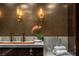 Upscale bathroom boasting a marble countertop, copper faucet, and stylish wall sconces, alongside elegant décor at 4575 Dean Martin Dr # 1909, Las Vegas, NV 89103
