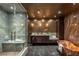 Elegant bathroom features marble shower with seat, unique copper tub, and marble tile floor at 4575 Dean Martin Dr # 1909, Las Vegas, NV 89103