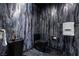 Unique powder room featuring designer marble wall finish, black fixtures, and pedestal sink at 4575 Dean Martin Dr # 1909, Las Vegas, NV 89103