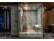 Modern bathroom boasts a large, marble-tiled glass shower with rainfall showerhead and built in seat at 4575 Dean Martin Dr # 1909, Las Vegas, NV 89103