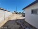A spacious backyard enclosed with block walls, features hardscape and desert landscaping at 4808 Everman Dr, Las Vegas, NV 89122
