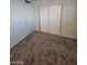 Bedroom showcasing neutral carpet, a closet, and a door, offering functional design at 4808 Everman Dr, Las Vegas, NV 89122