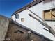 Exterior view of home with damaged siding, and overgrown foliage at 4808 Everman Dr, Las Vegas, NV 89122