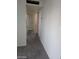 Hallway with neutral walls, a door, and a glimpse of another room, creating depth at 4808 Everman Dr, Las Vegas, NV 89122