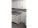 This kitchen features ample storage with sleek, white cabinetry and granite counters at 4808 Everman Dr, Las Vegas, NV 89122