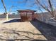 An exterior shot of a weathered shed in the backyard surrounded by bare trees at 4808 Everman Dr, Las Vegas, NV 89122