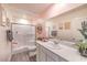 Bright bathroom with glass shower, grey vinyl floors, white vanity, and pink walls at 5011 Sage Mesa Ave # Lot 143, Las Vegas, NV 89139