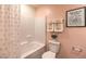 Bright bathroom featuring a shower-tub combo with white tile and a whimsical piece of wall art at 5011 Sage Mesa Ave # Lot 143, Las Vegas, NV 89139