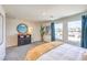 Bright bedroom featuring a black dresser, neutral carpeting, and exterior views through the windows at 5011 Sage Mesa Ave # Lot 143, Las Vegas, NV 89139